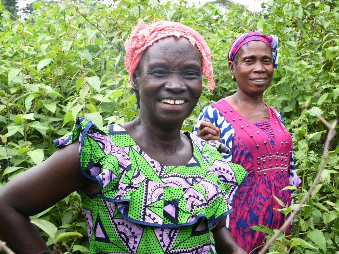 Two women smiling among their crops