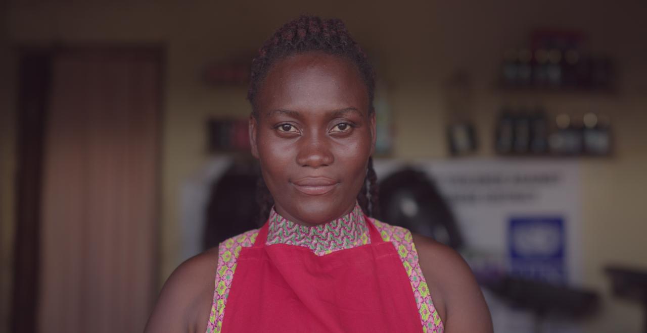 A smiling woman looks into camera