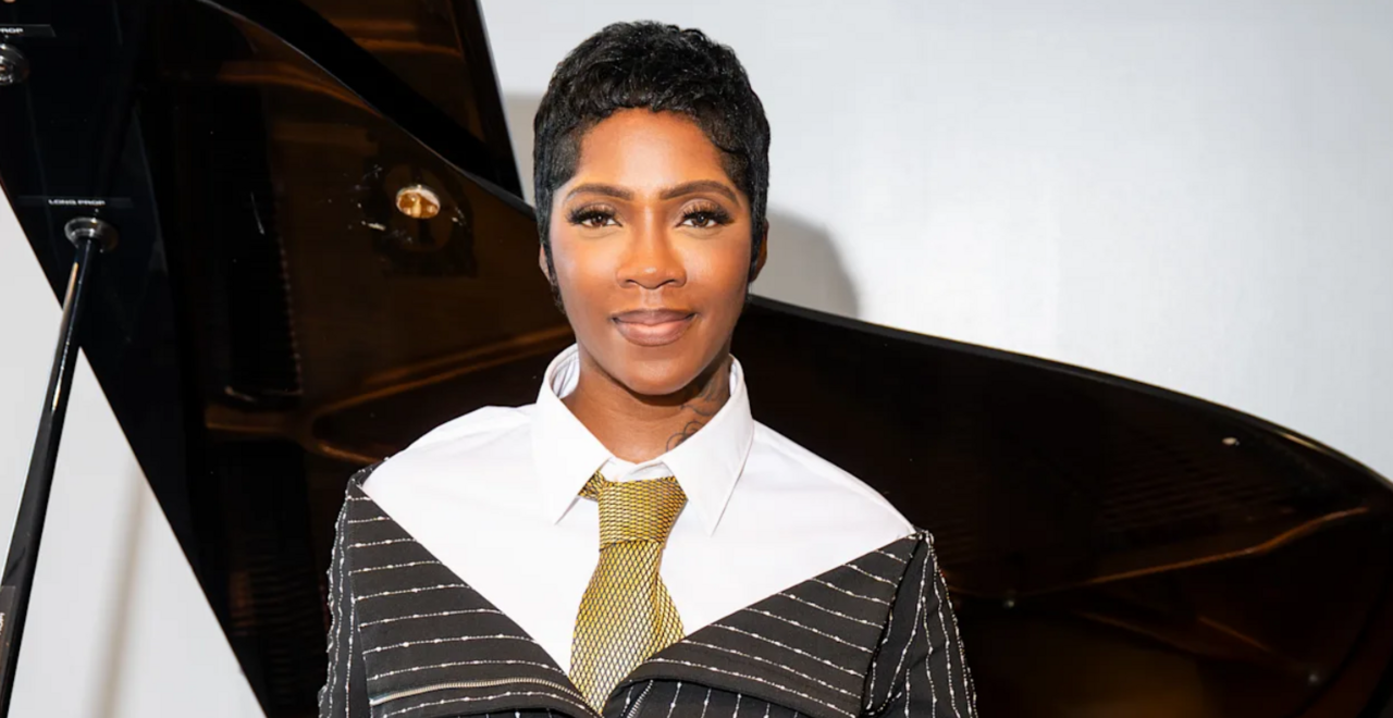 Tiwa Savage standing in front of a piano