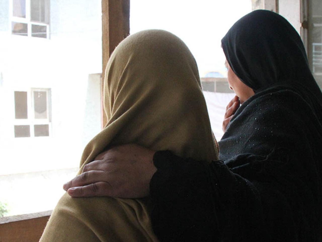 Two women looking out window