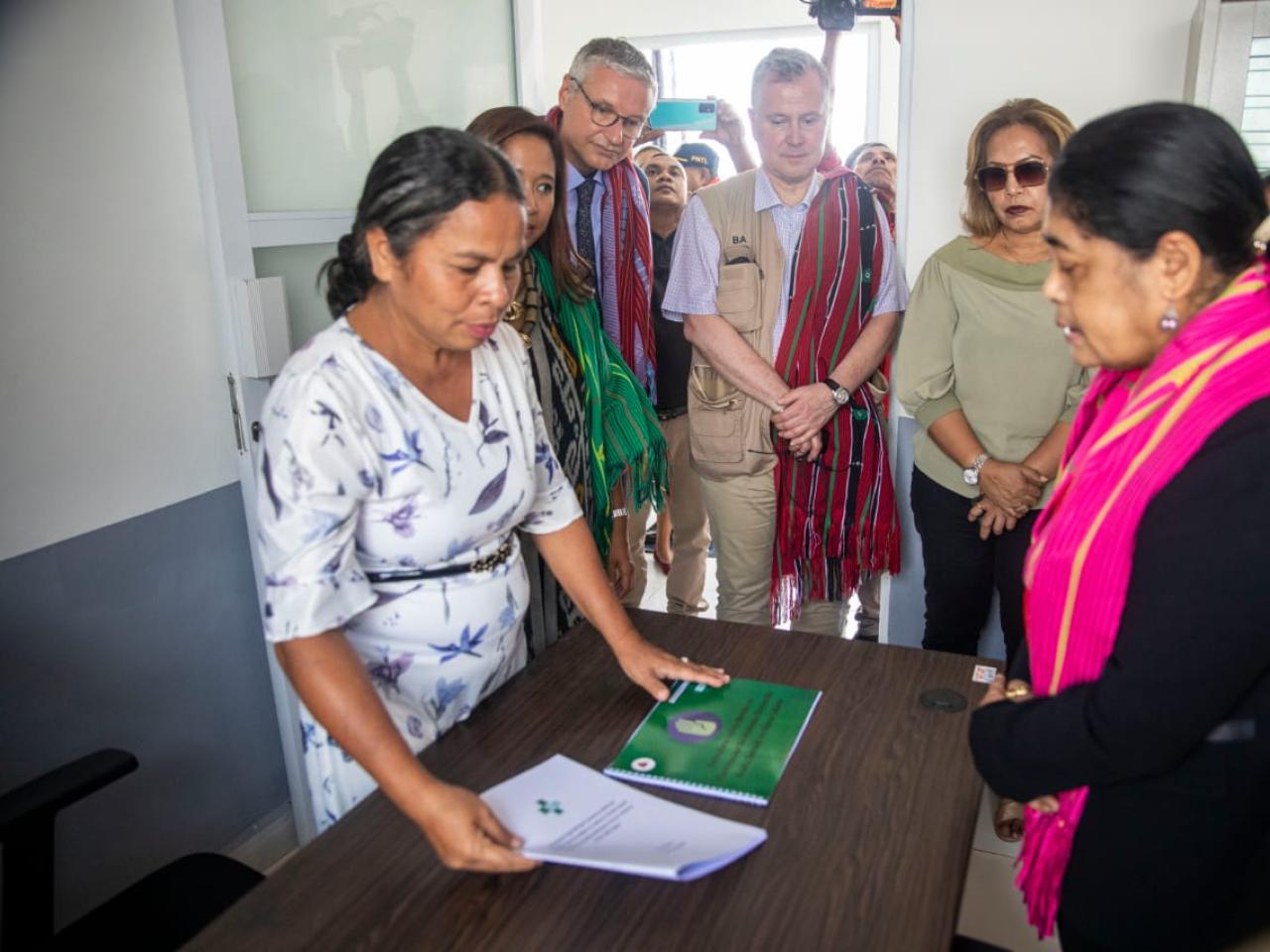 Women and men looking at documents on a desk