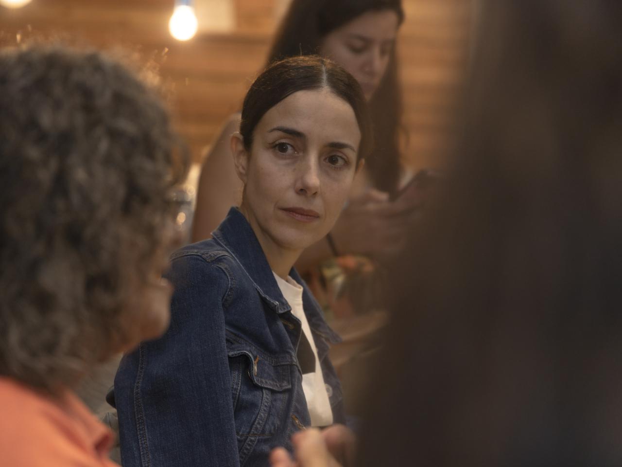 Close up of Cecilia Suarez listening to activist