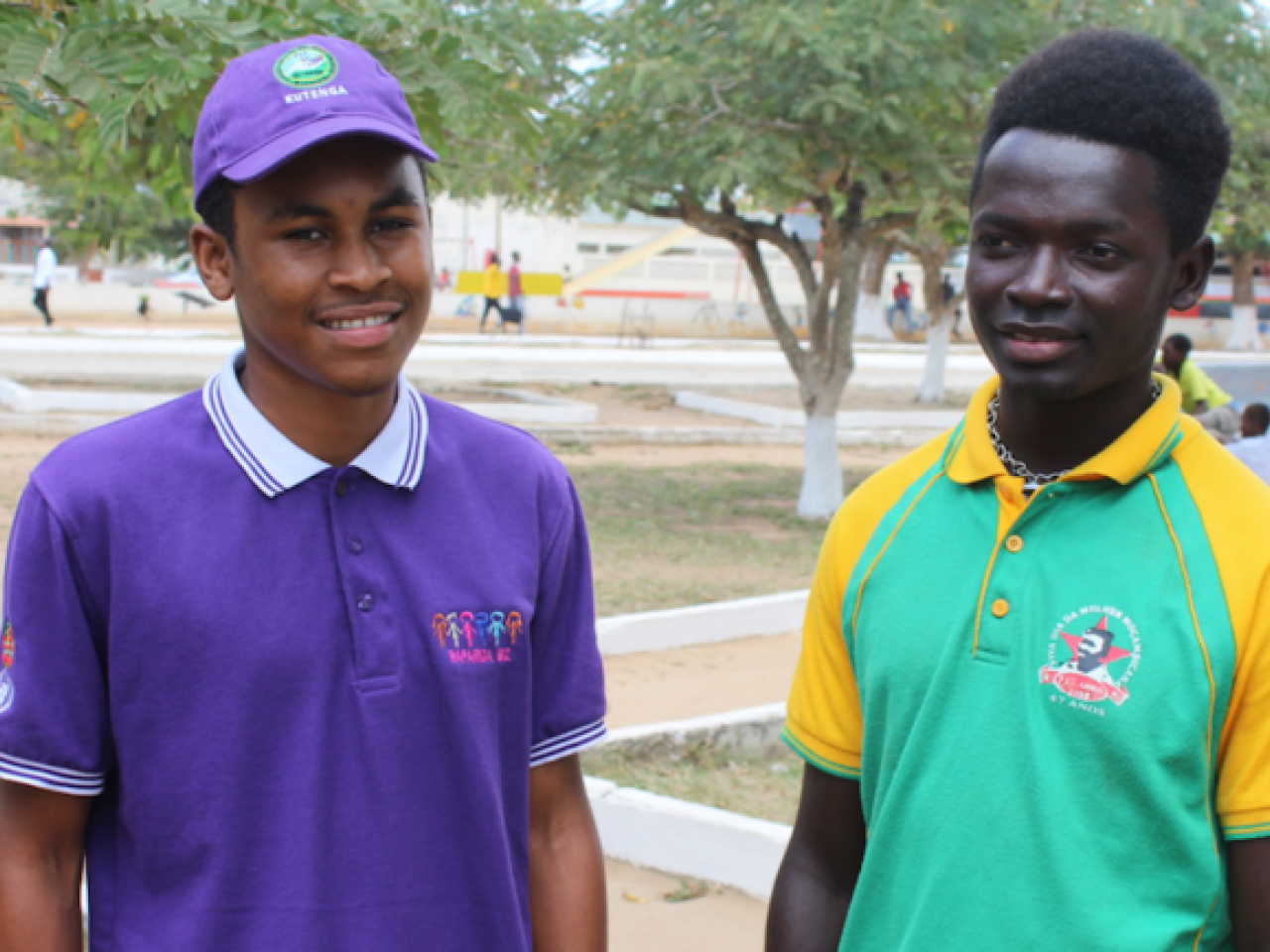 Two young men stand beside each other