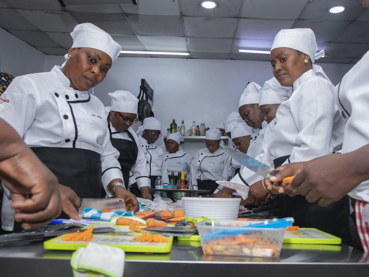 Women chefs gather around table