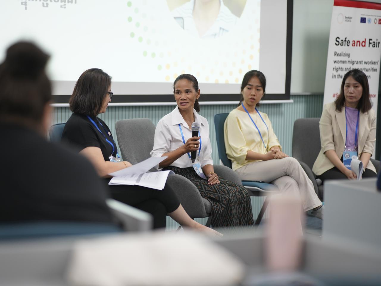 a group of women sitting on a panel