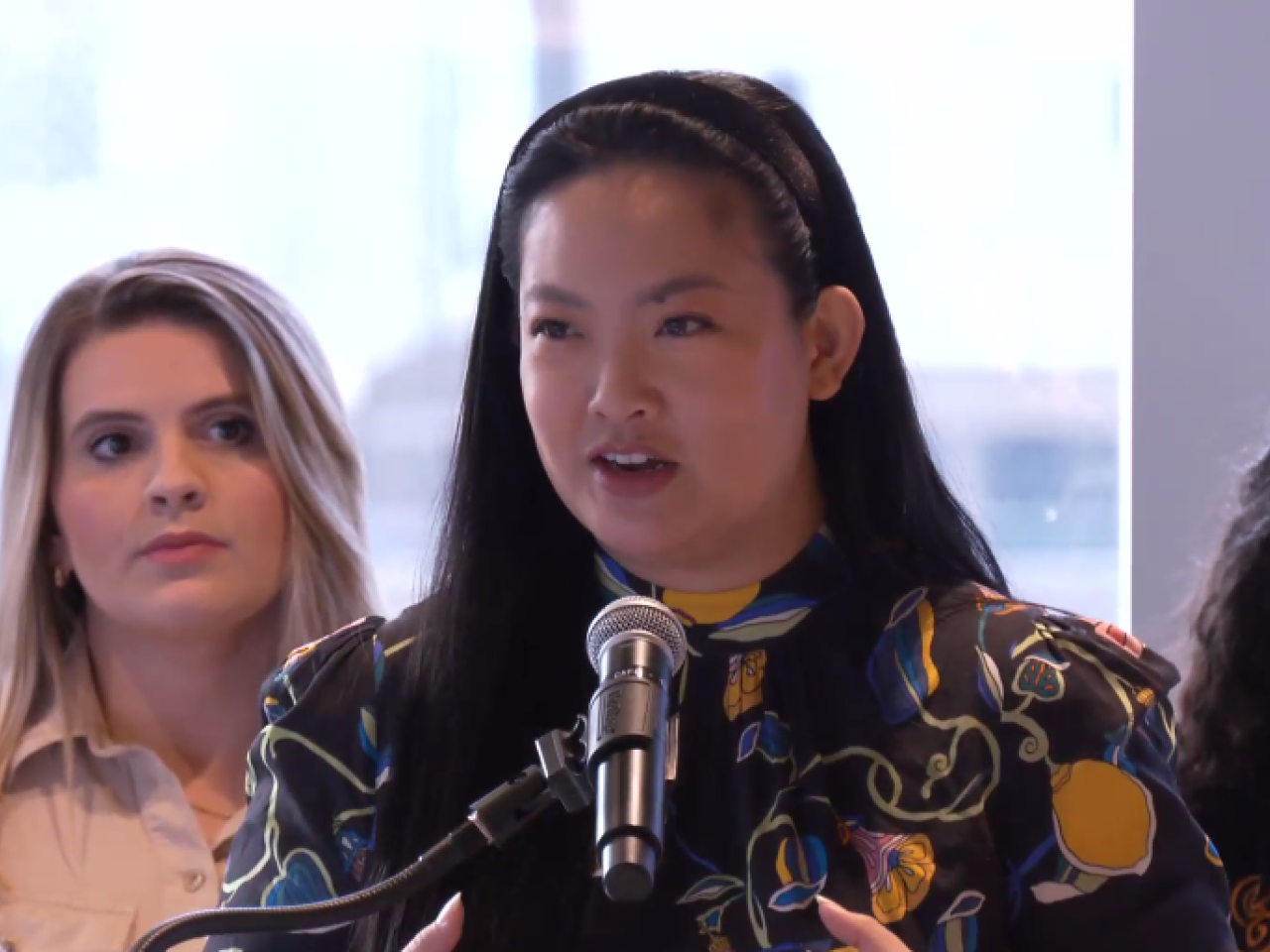 Amanda Nguyen speaking at lectern