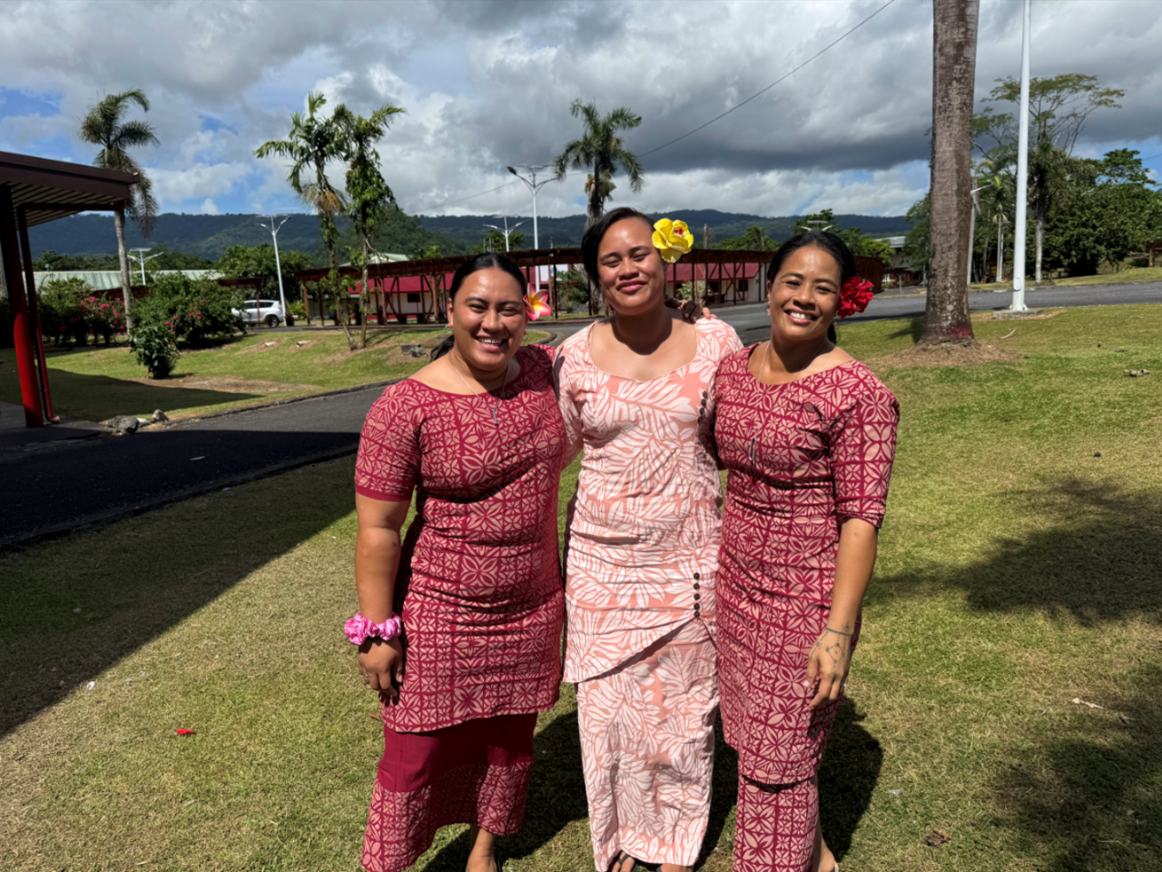 Rugby league players  Anasis Afi’a and Atitoafaiga Tau-Ioapo with Apelu Sports Founder Gabrielle Gabrielle Fuatino Apelu smiling in an outdoor setting