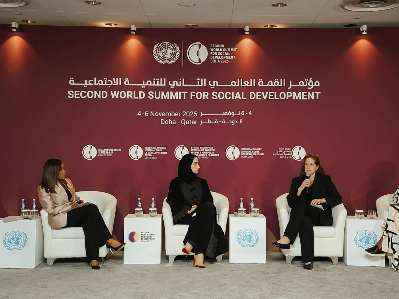 Panel of four women seated on stage