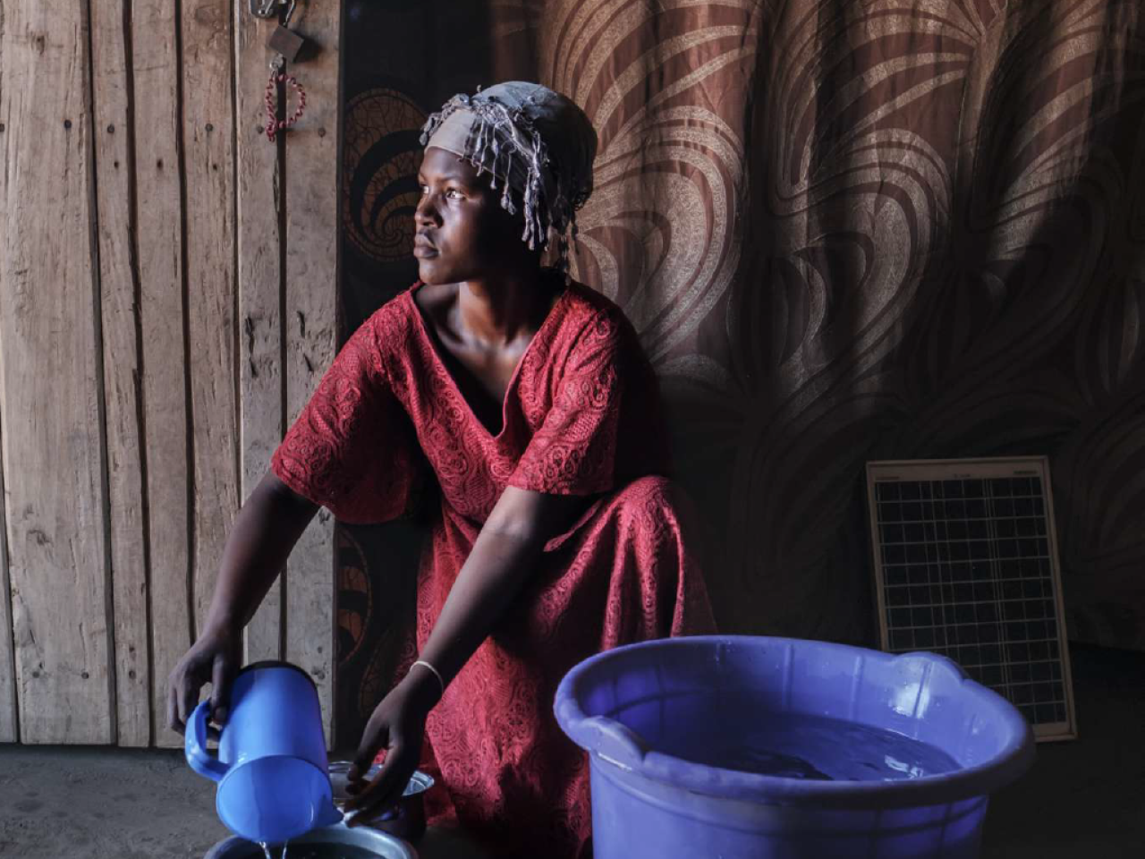 A woman in a doorway wearing a red dress