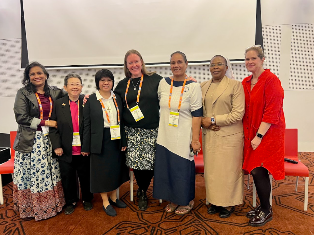 7 women smiling at camera