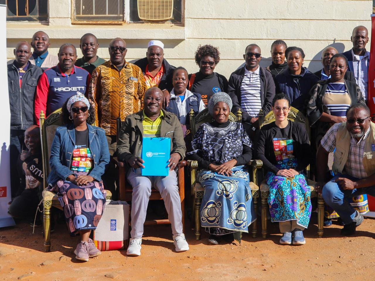 A photo of Chief Chanje of Eastern Zambia with UN and Civil Society representatives at his chiefdom. The chief supports gender equality and women's empowerment. 