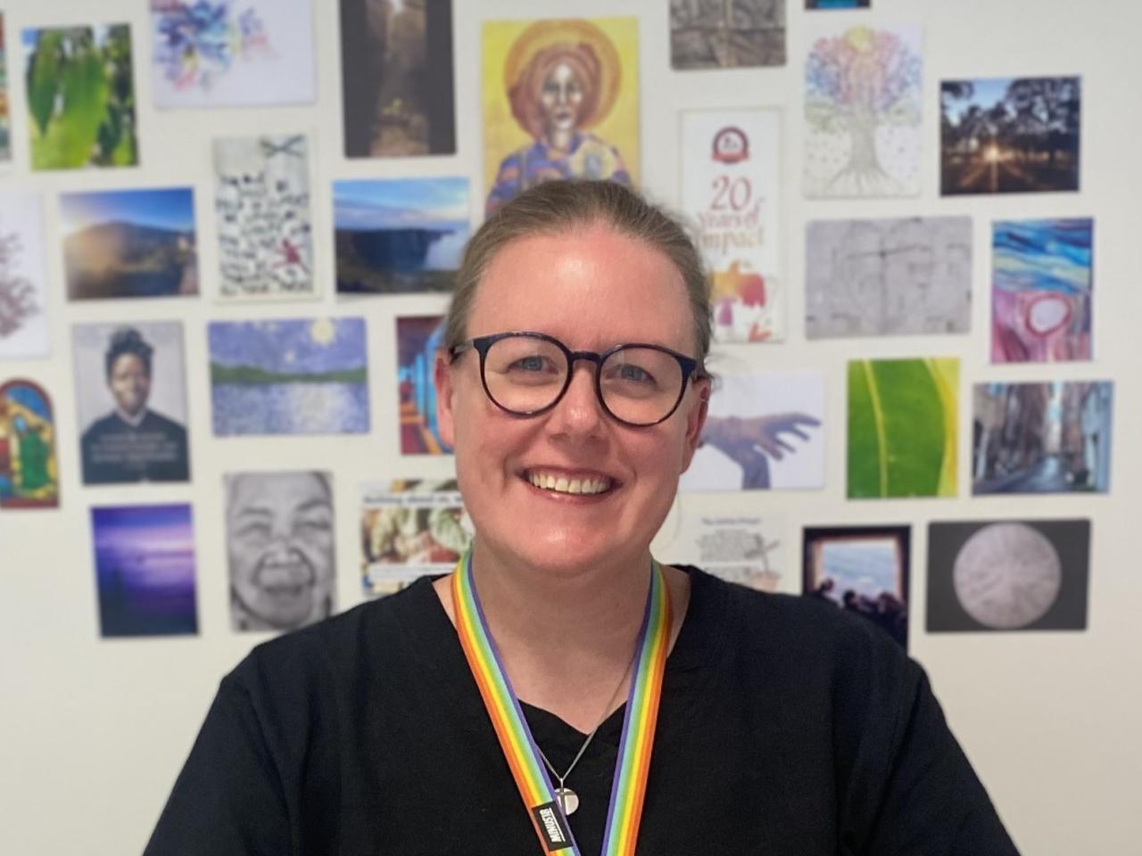 Sarah Puls wearing glasses and smiling at camera