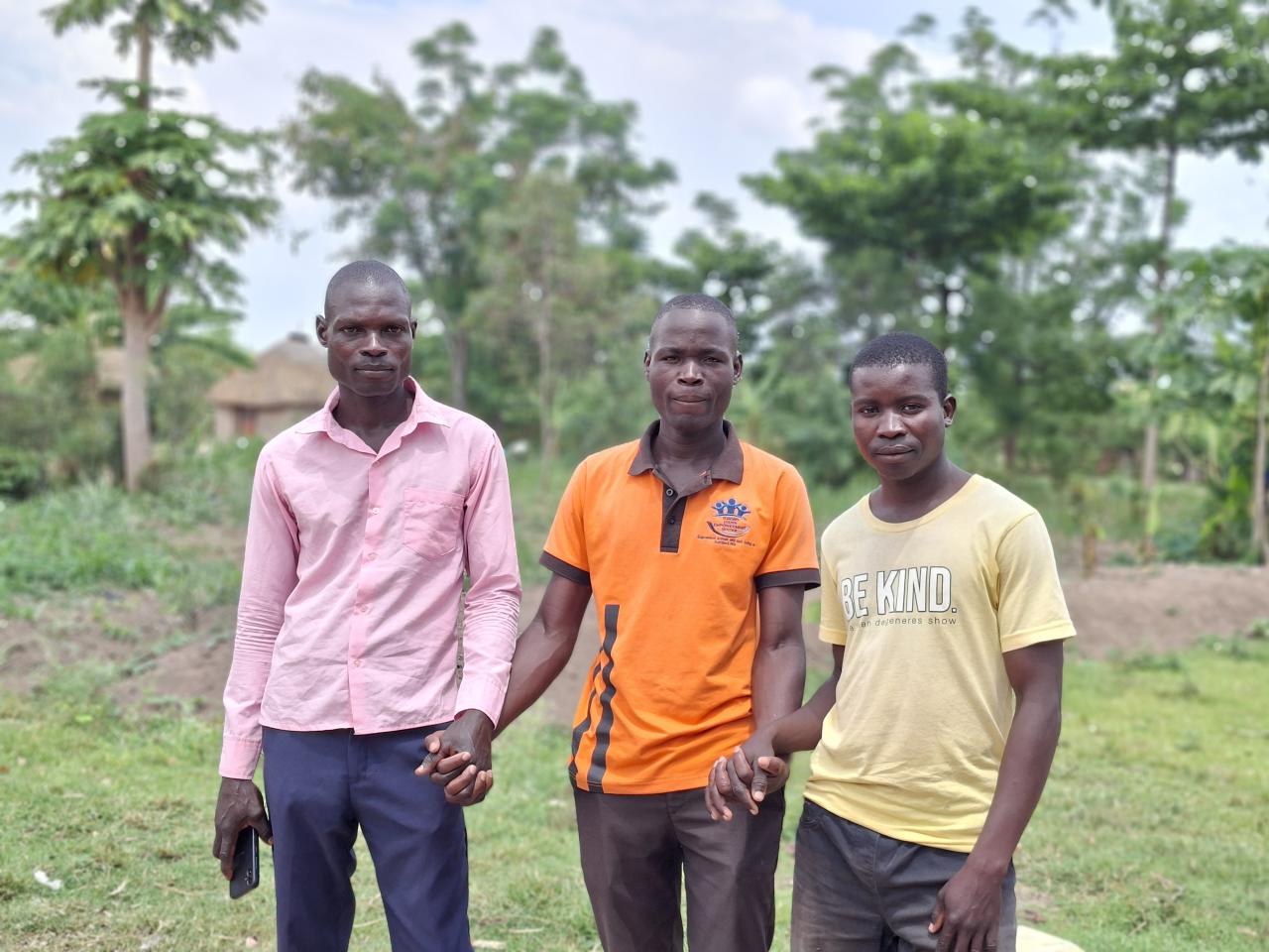 Onyango Vincent (middle) and his mentees, Owere Patrick (L) and Ochieng David joining hands