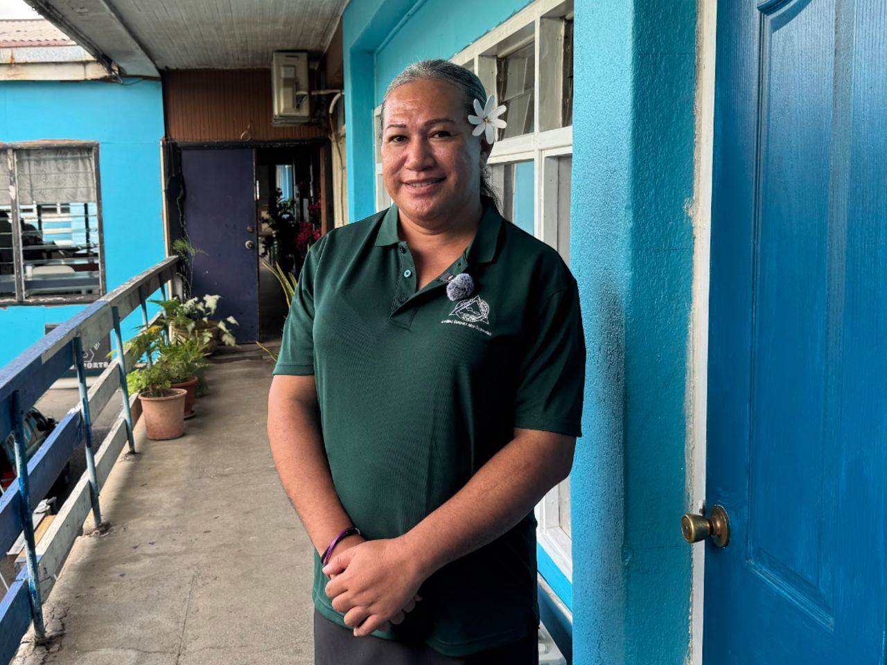 Fagalima standing on a balcony at SFA office