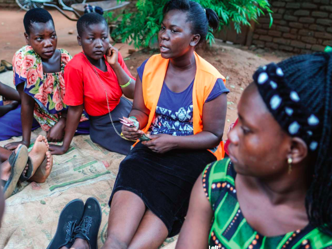 Elestina Joseph seated with other women in discussion