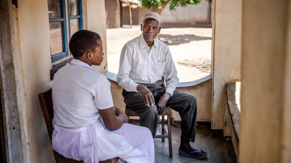 Man in conversation with young woman