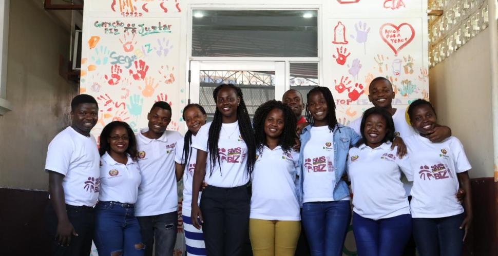 Smiling men and women in white t-shirts