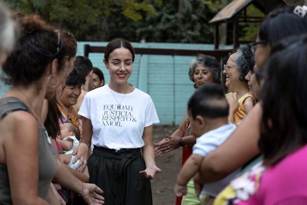 Ms Suarez walking between two rows of women with eyes closed