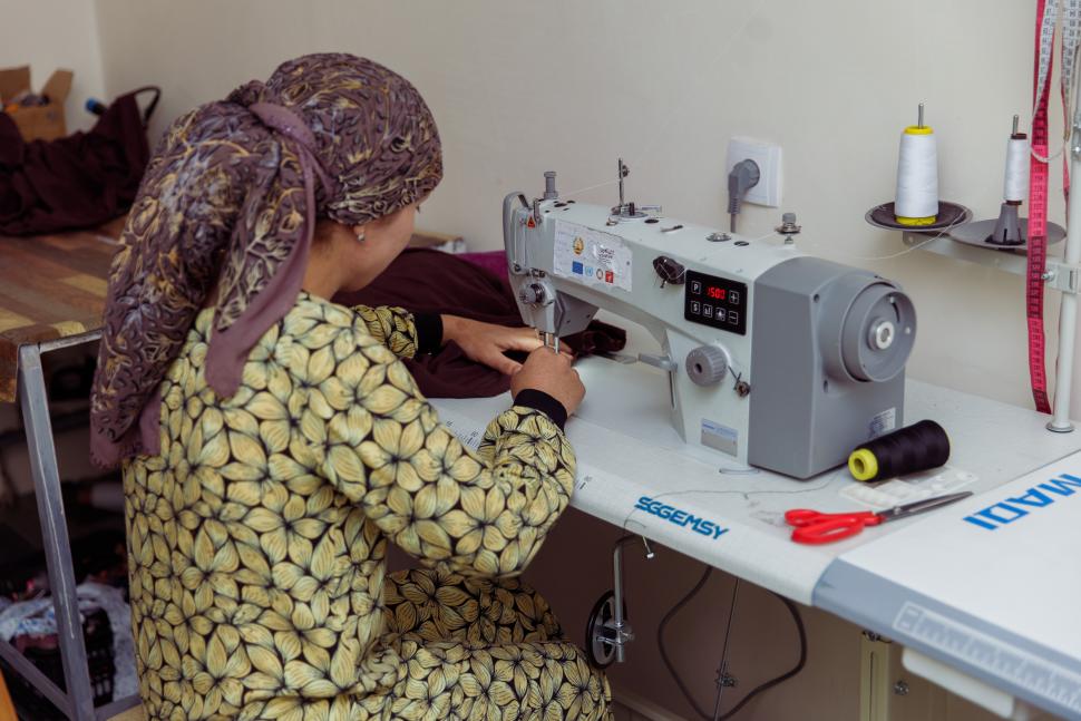 Woman seated at sewing machine