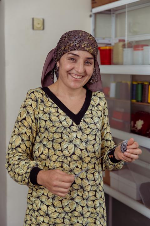 Smiling woman holding tape measure