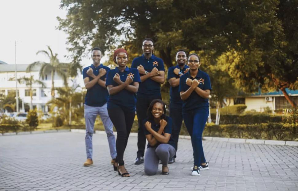 Men and women in matching shirts with arms crossed