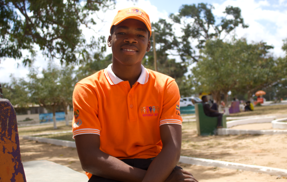 Smiling boy in orange shirt