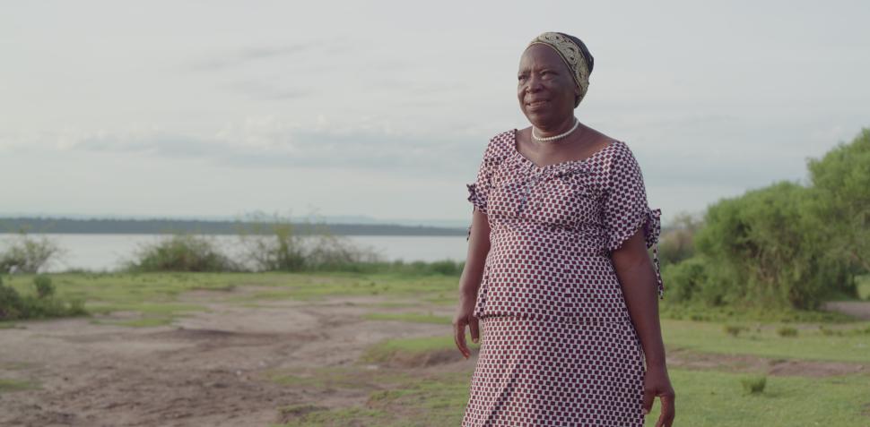 Woman standing near lake looking at landscape