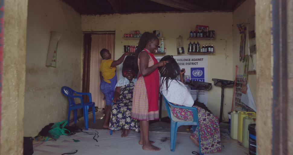 Women smiling in a busy hair salon