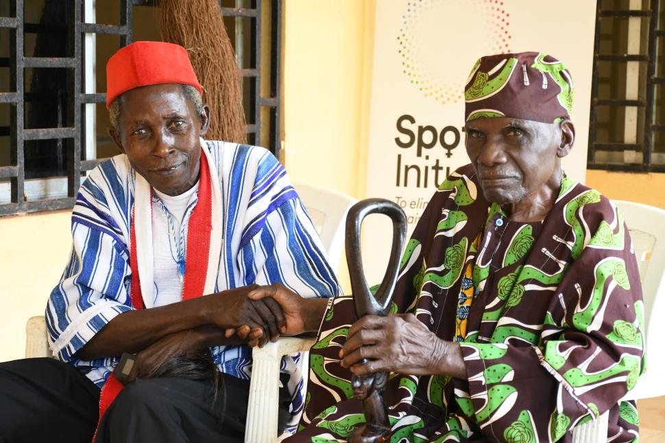 Two seated men in traditional dress