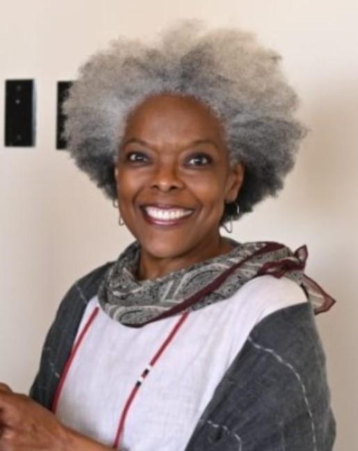 A smiling woman wearing a scarf