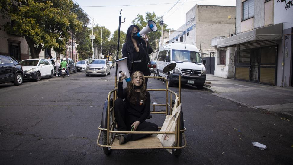 Two girls with megaphones posing in middle of road