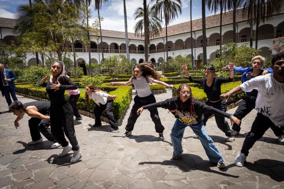 Young people performing a dance in a courtyard