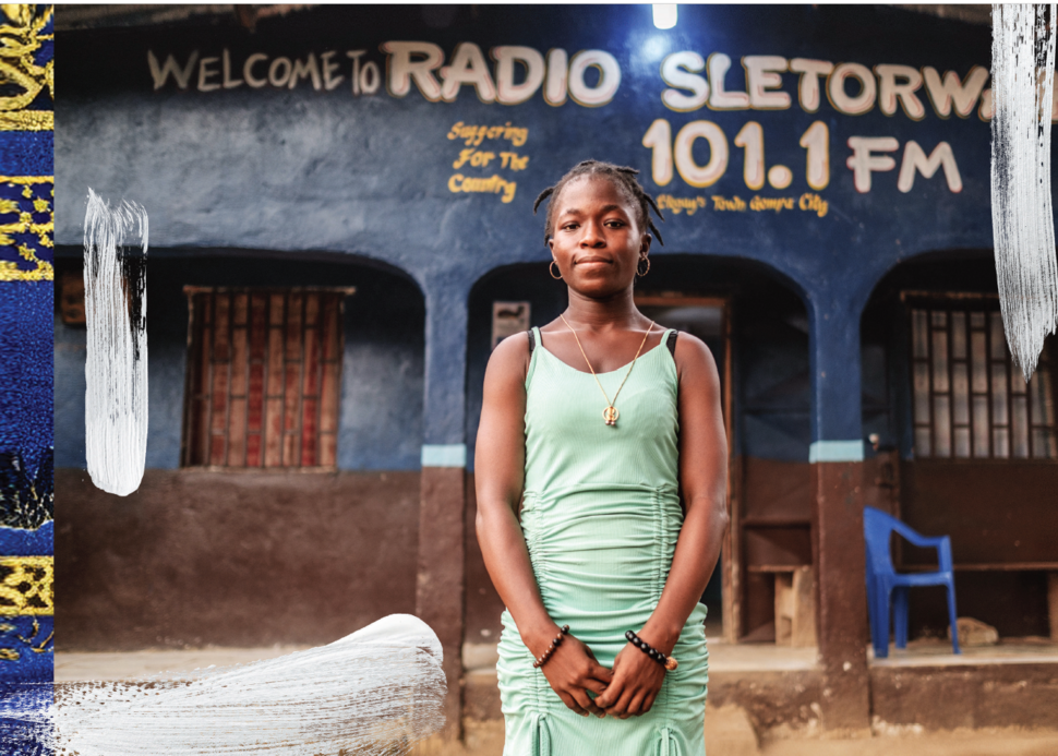 A woman in a green dress stands outside a building that reads Radio Sletorwah