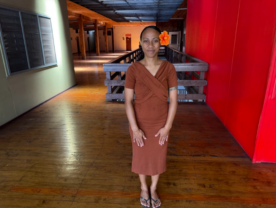 Miracle Afele smiling with a hibiscus flower behind her ear