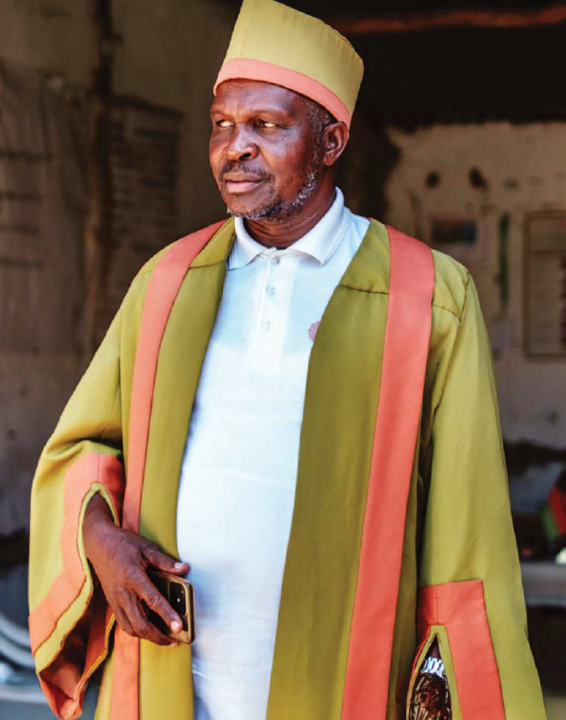 Chief Kind Rajabu wears green and orange formal attire