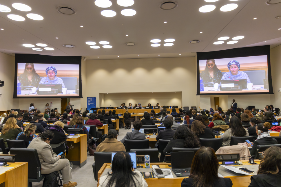 Audience looks towards panel in conference space