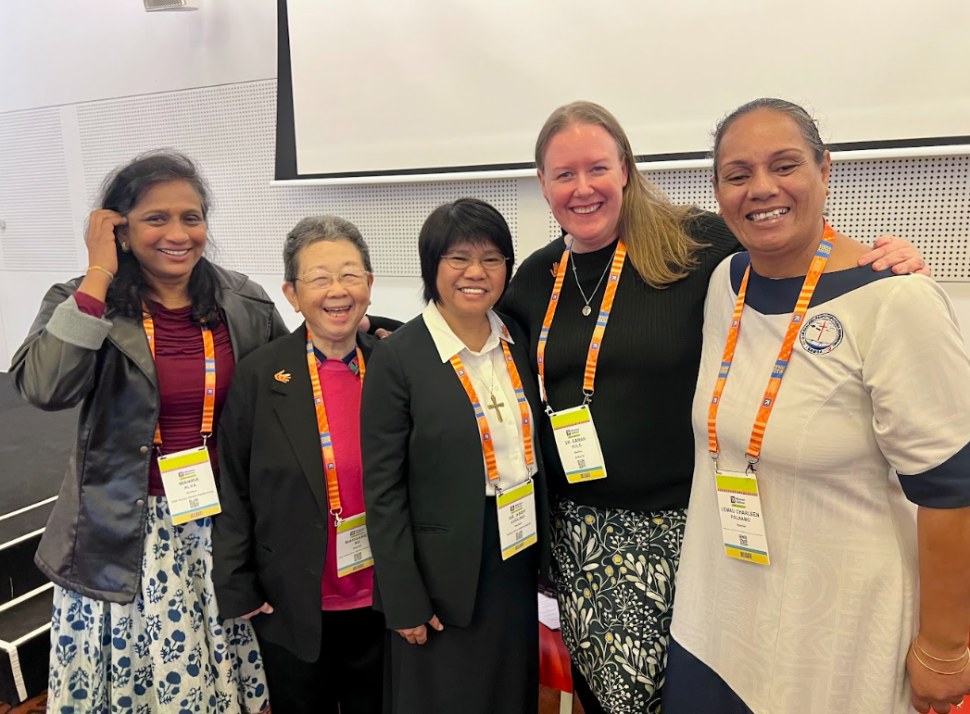 Five women standing together