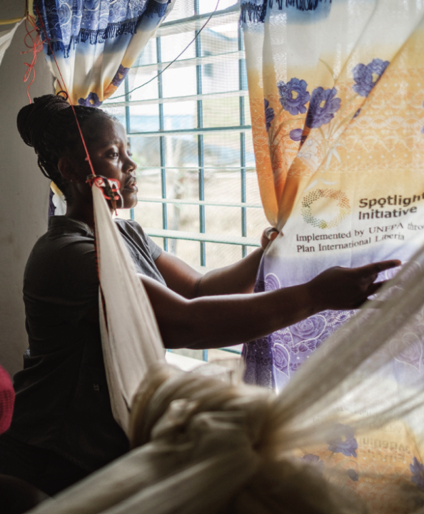 Koro Mallah closing window curtains at the health centre 