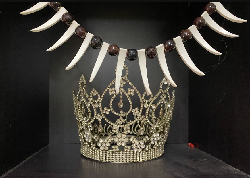 A diamante crown sitting on a shelf.