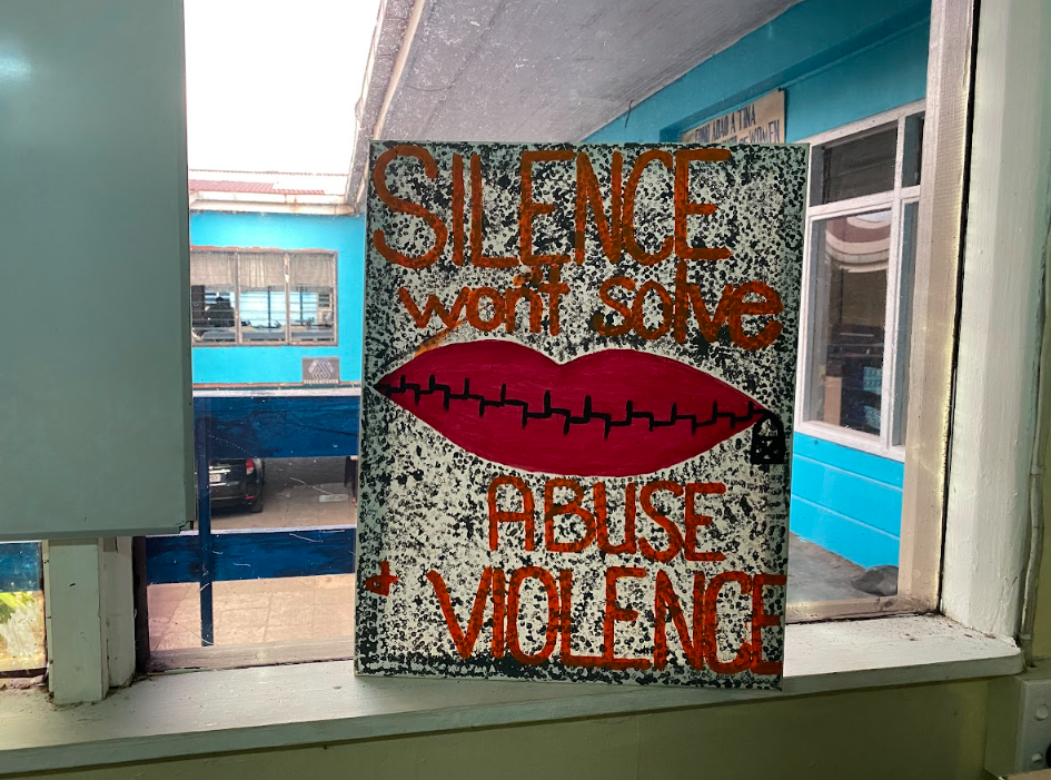 A sign in a window reads 'silence won't solve violence"
