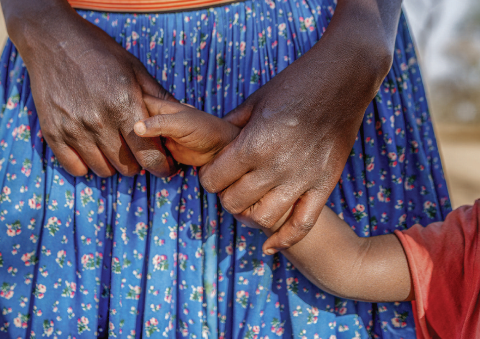 A mother's hand holding a child's hand