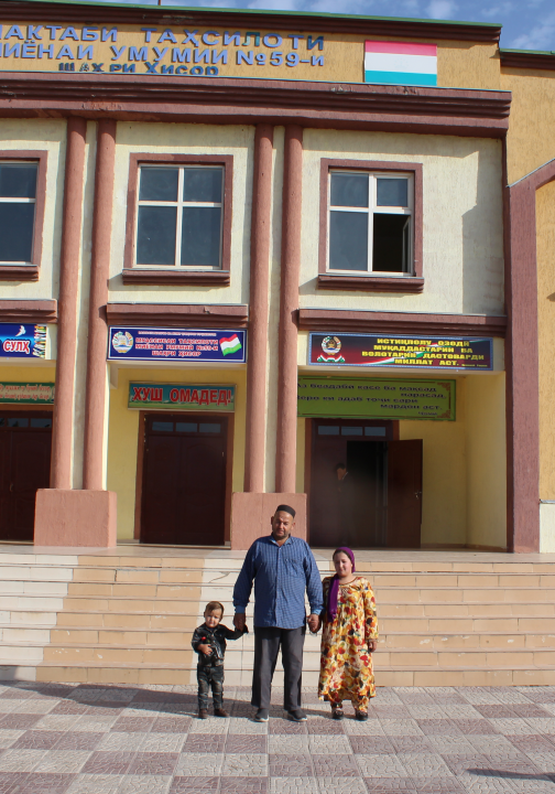 Three figures in front of school