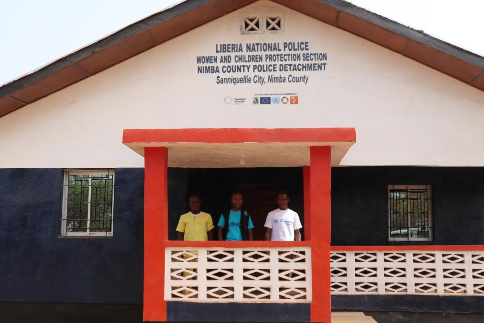 Three people standing in front of building