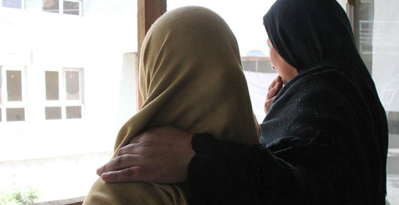 Two women looking out window