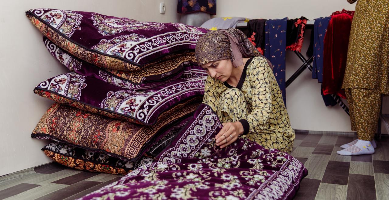 Woman inspecting decorative rugs