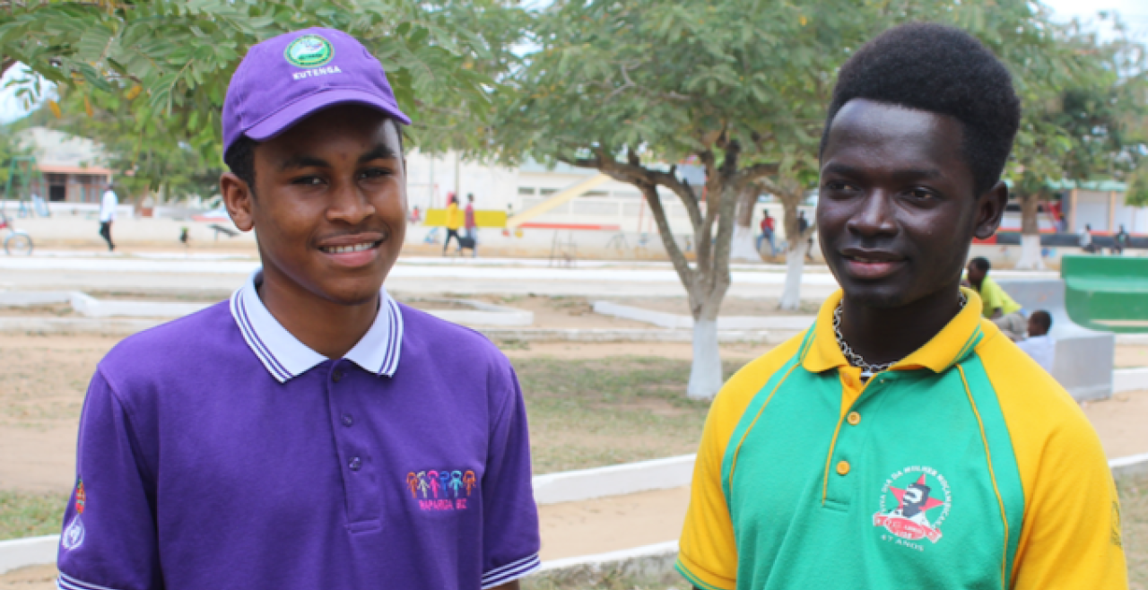 Two young men stand beside each other