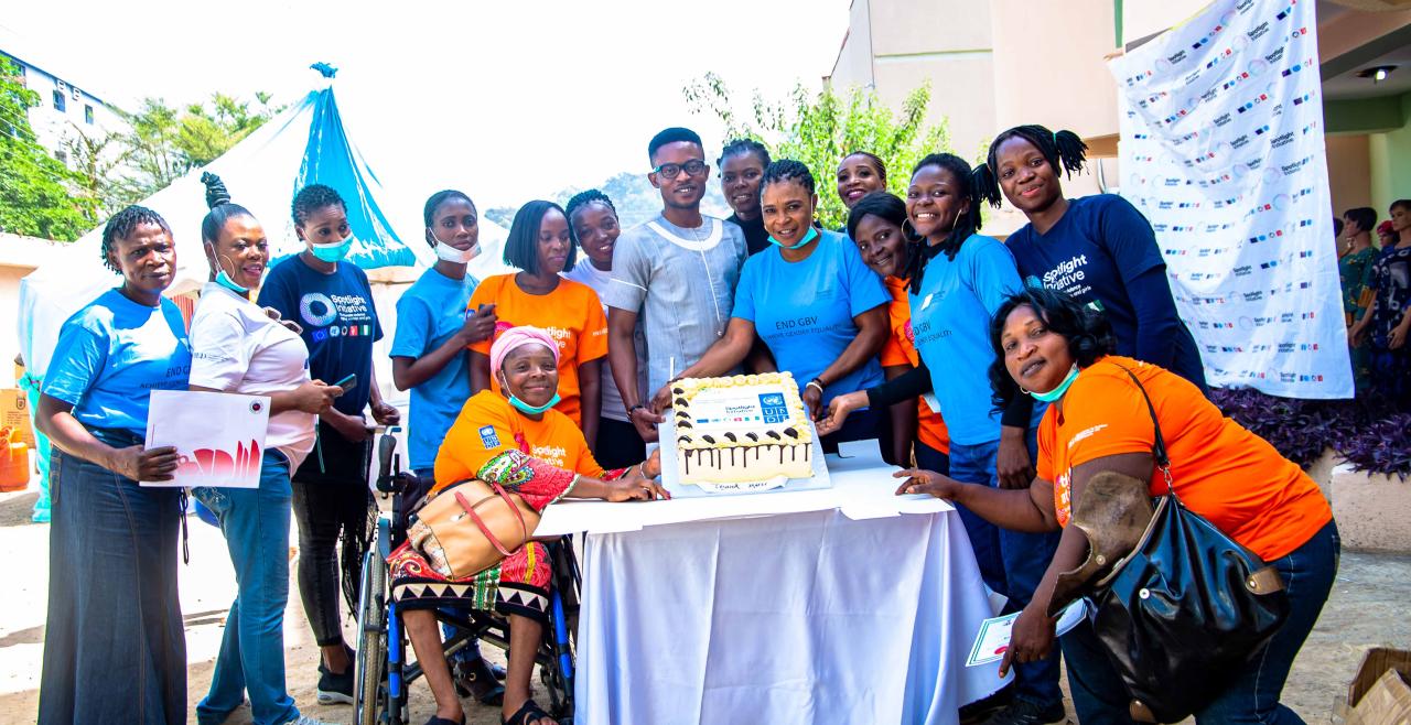 Women gathered around a cake