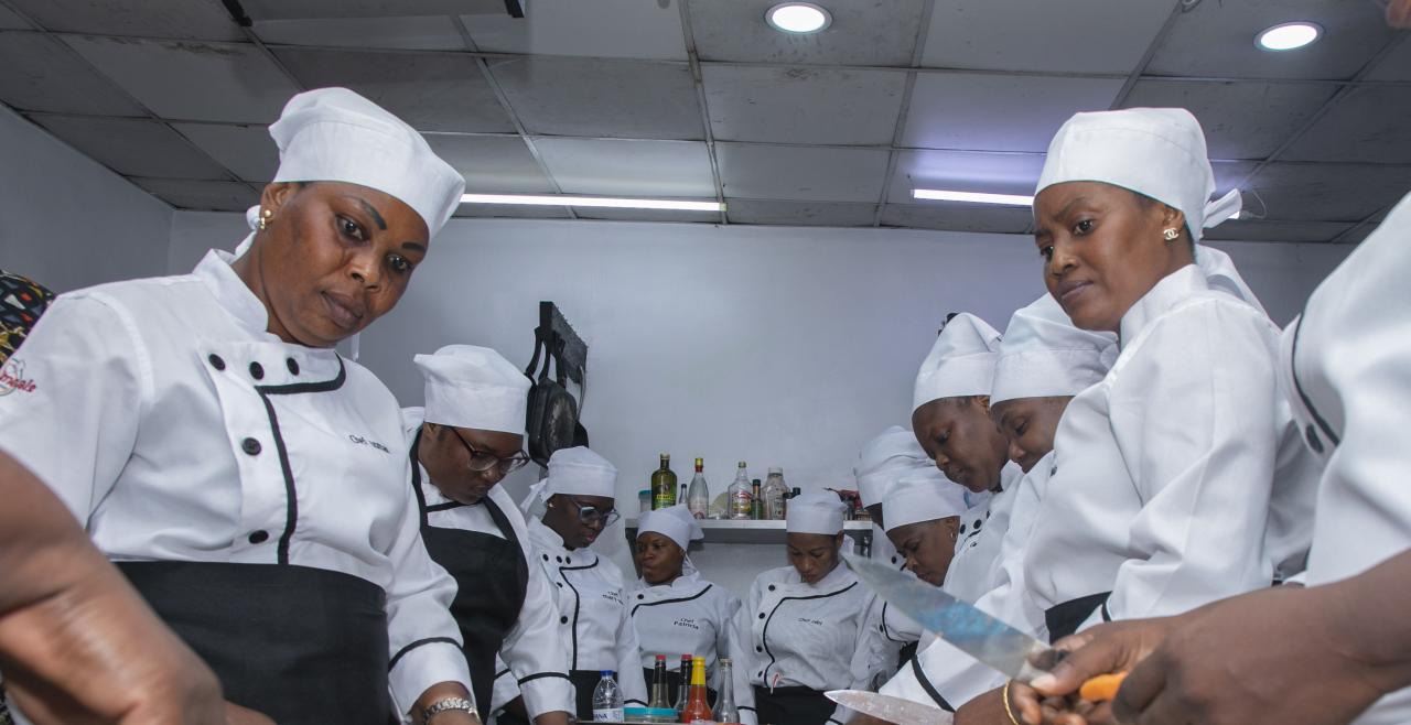 Women chefs gather around table