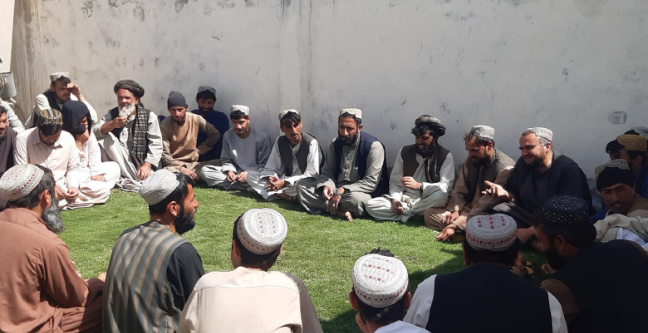 Men seated in circle