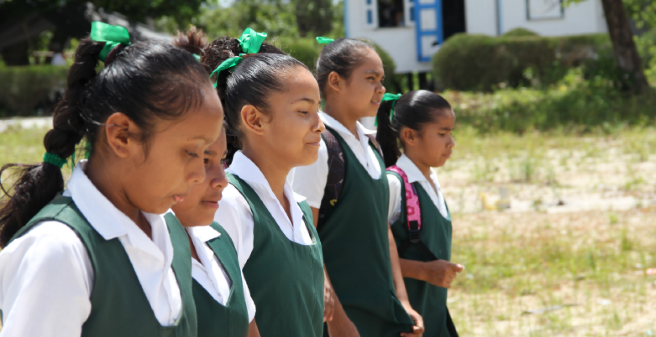 Five female students walking in a line